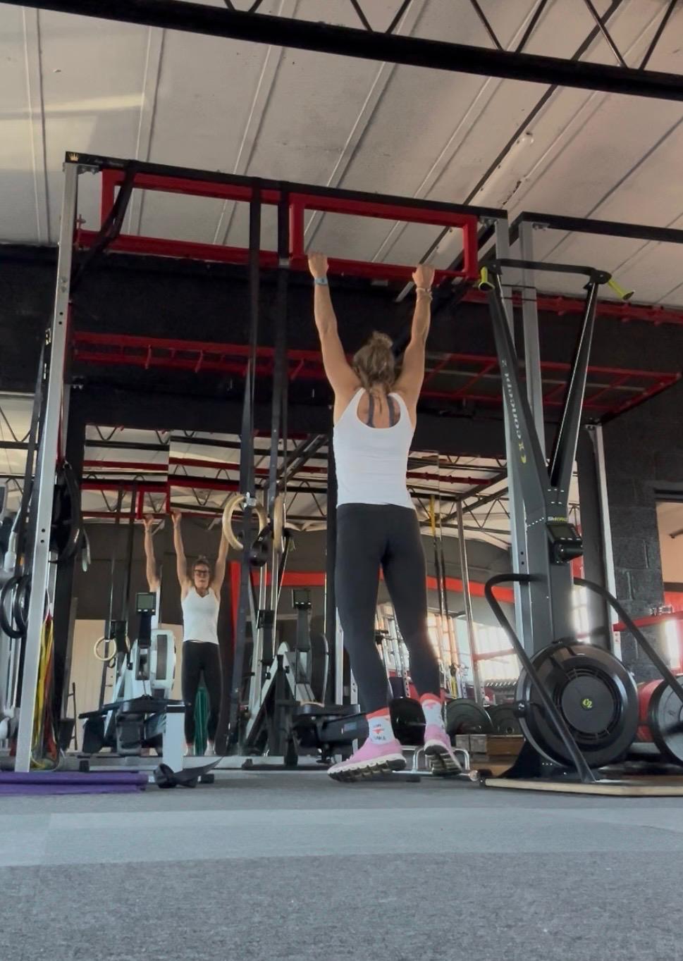 Chloe training with a client in the gym